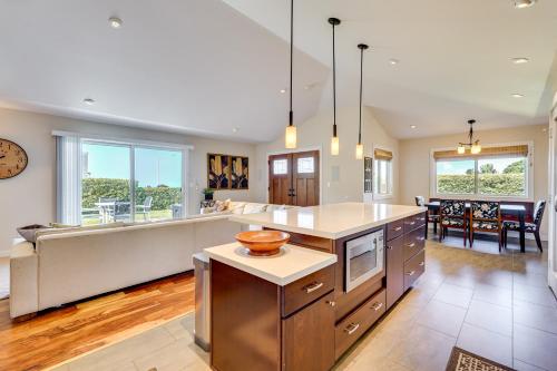 a kitchen with a large island and a living room at Kona Coast Hideaway with Patio and Pacific Ocean Views in Kailua-Kona