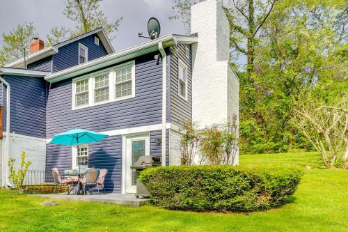 a blue house with a table and a blue umbrella at Less Than 1 Mi to Wineries Quaint and Cozy Waterford Studio in Waterford