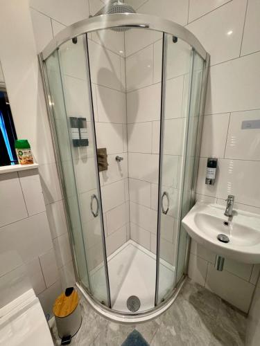 a bathroom with a shower and a sink at 40th Avenue Guest House in Mill Hill