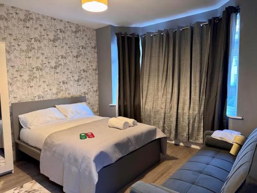 a small bedroom with a bed and a chair at 40th Avenue Guest House in Mill Hill