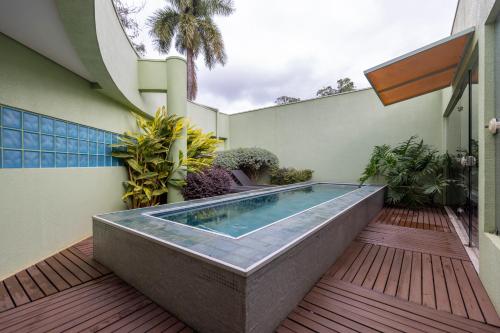 a hot tub on the deck of a house at Sanma Hotel in Foz do Iguaçu