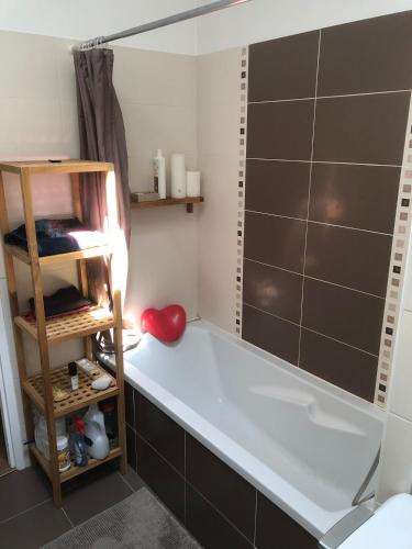 a bath tub in a bathroom with a shelf at Surf, Skate, Golf house Seignosse in Seignosse