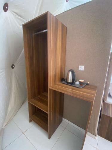 a wooden cabinet in the corner of a room at Wadi Rum Santa Camp in Wadi Rum