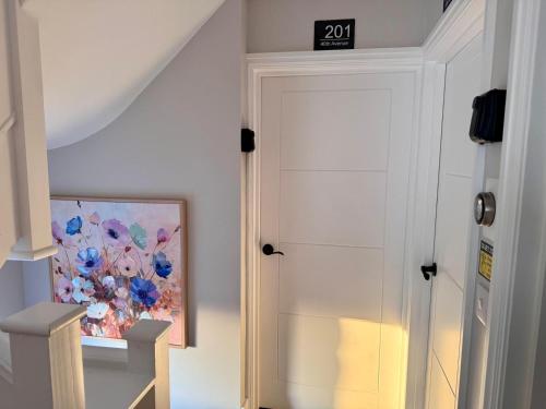 a door in a room with a painting on the wall at 40th Avenue Guest House in Mill Hill