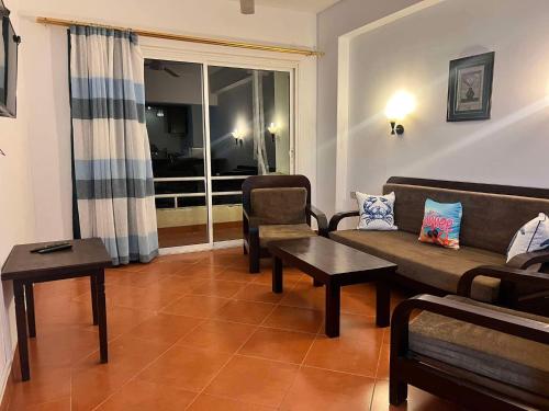 a living room with a couch and a table at Sea Life Apartments-hotel in Hurghada