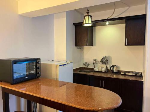 a kitchen with a counter top with a microwave at Sea Life Apartments-hotel in Hurghada