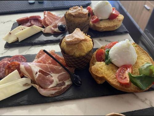 a tray of muffins and pastries on a table at L'Angolo di Gaudì, casa Milà in Putignano