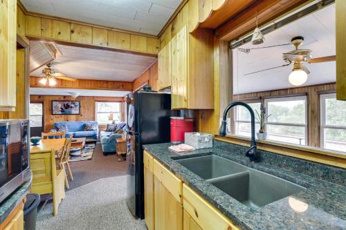 a kitchen with a sink and a refrigerator at Walk to Wyalusing Beach Cabin with River View! in McGregor