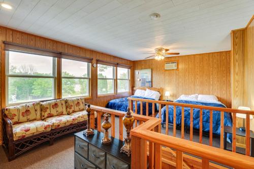 a bedroom with a bed and a couch at Walk to Wyalusing Beach Cabin with River View! in McGregor
