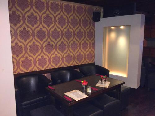 a table and chairs in a room with a wall at Kilford Arms in Kilkenny
