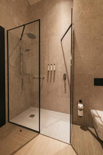 a shower with a glass door in a bathroom at Hotel Cabo De Hornos in Punta Arenas