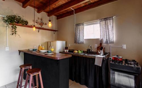 a kitchen with a large island in a room at Moradas do Vale Praia do Rosa in Praia do Rosa