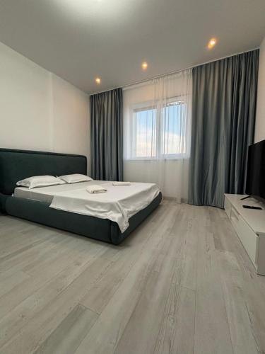 a bedroom with a bed and a wooden floor at CAMA Vip Room's in Bucharest