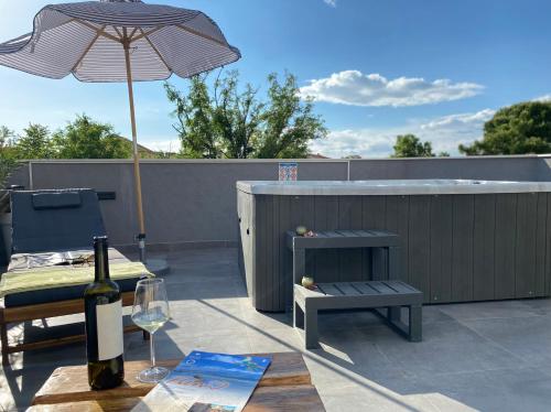 a bottle of wine on a table with a wine glass at Studio apartment Dalmatia in Nin