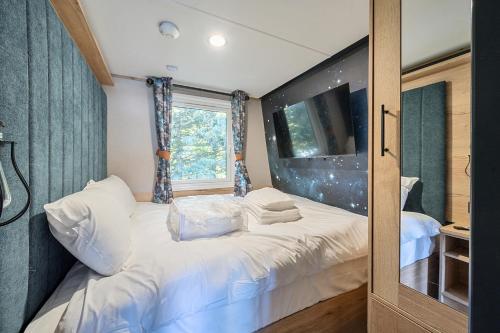 a small bedroom with a white bed with a window at Starlight Skylight - Billing Aquadrome in Northampton