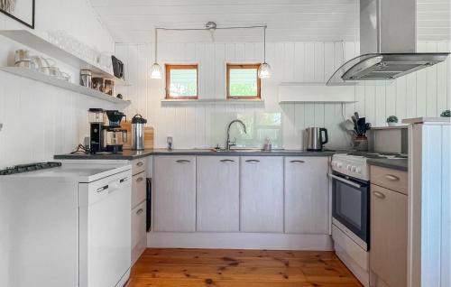 a kitchen with white cabinets and a sink at Nice Home In Eskebjerg With Wifi in Eskebjerg