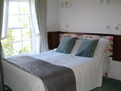 a bedroom with a large bed with a window at Terrace hotel in Edinburgh