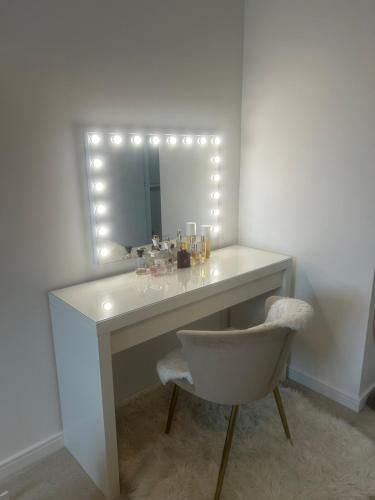 a dressing table with a chair and a mirror at Beautiful apartment in Chichester
