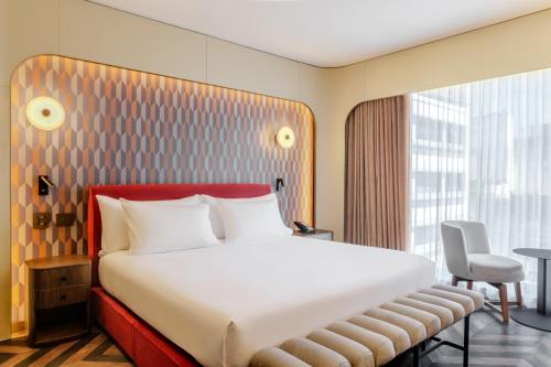 a hotel room with a large bed and a window at Recoleta Grand, Buenos Aires, a Tribute Portfolio Hotel in Buenos Aires