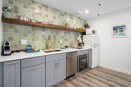 a kitchen with a sink and a refrigerator at Pismo Beach Club in Pismo Beach