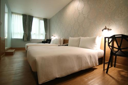 Postel nebo postele na pokoji v ubytování LIHO Hotel Hankou