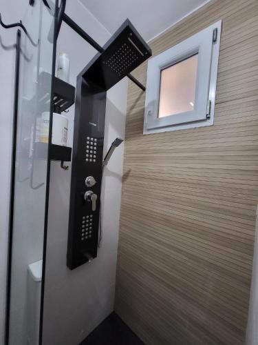 a bathroom with a shower with a television on the wall at Lila Natur León1 Apartment 4 Pers in Villafañé