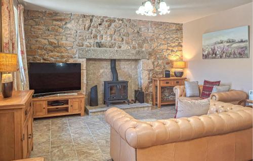 un salon avec un canapé et une cheminée dans l'établissement Ravissante Maison Bretonne, à Louargat