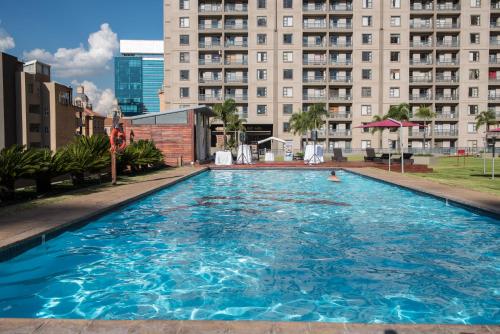a large swimming pool in front of a building at WeStay Westpoint Apartments in Johannesburg