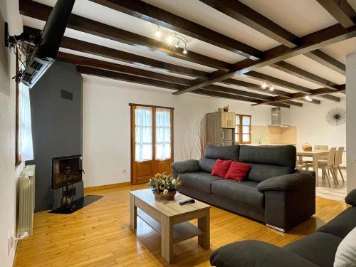 a living room with a couch and a table at Larrapil in Etxalar