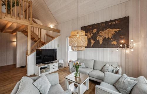 a living room with a couch and a tv at Awesome Home In Ostseeresort Olpenitz in Olpenitz