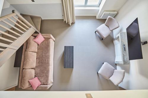 a staircase in a house with pink pillows at Appart'hôtel Odalys City - Dijon Centre Les Cordeliers in Dijon