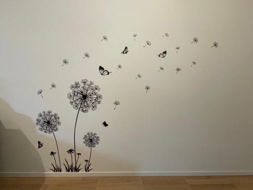 a wall with butterflies and dandelions in a room at Casa Tina in Ravenna