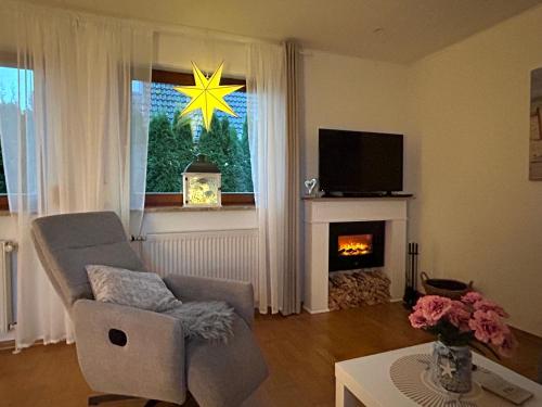 a living room with a chair and a fireplace at Ferienhaus Lines to Huus bei Heiligenhafen und Großenbrode in Heiligenhafen