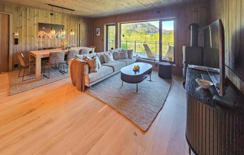 a living room with a couch and a table at Stunning Apartment In Hemsedal in Hemsedal