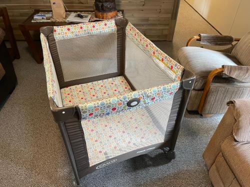 a baby crib with a covering on it in a room at Grandma's Home in the Woods. Yellowstone in Island Park