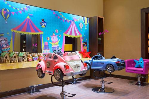 a room with two toy cars on a stage at Londoner Grand, a Luxury Collection Hotel, Macau in Macau