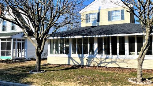 a house with two trees in front of it at 409 Princeton in Cape May Point