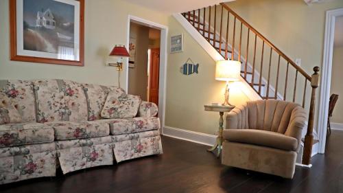 a living room with a couch and a chair at 409 Princeton in Cape May Point
