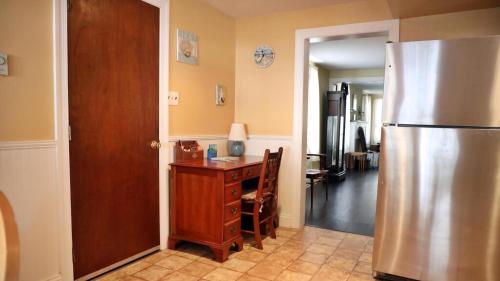 a kitchen with a refrigerator and a wooden table at 409 Princeton in Cape May Point
