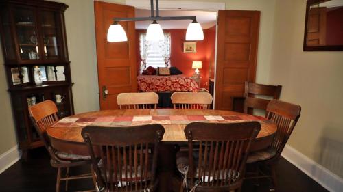 a dining room with a table and chairs and a bedroom at 409 Princeton in Cape May Point