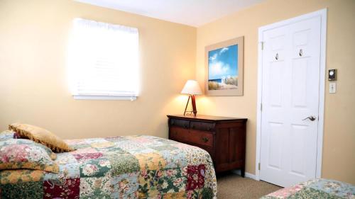 a bedroom with a bed and a dresser and a window at 409 Princeton in Cape May Point