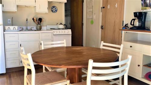 a kitchen with a wooden table and chairs at Somewhere In Time Unit 4 in Cape May Point