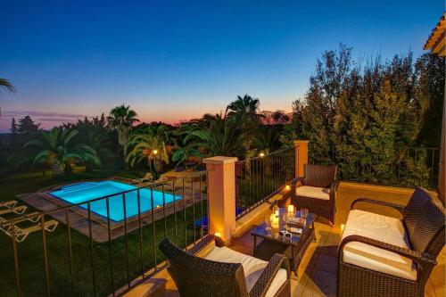 a patio with chairs and a swimming pool at Villa Marino by Villa Plus in Cala d´Or