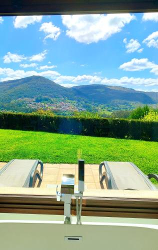 a room with a window with a view of a field at Casa nueva en Vigo Rural Mos con Jacuzzi y chimenea in Pontevedra