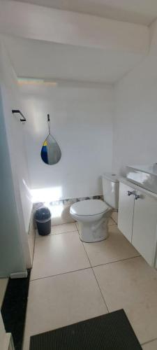 a bathroom with a white toilet in a room at Pousada do sol in Sorocaba