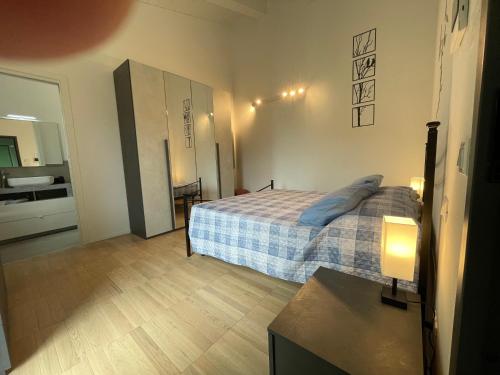 a small bedroom with a bed and a bathroom at Casa Tina in Ravenna