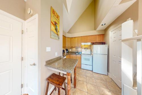a kitchen with a table and a refrigerator at Condo 614 at North Creek Resort in Blue Mountains