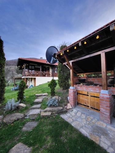 a house with a stone walkway and a building at Apartmani Lunija in Gornji Milanovac