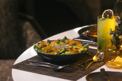 a table with a bowl of vegetables on a table at Hotel Cabo De Hornos in Punta Arenas