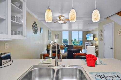 a kitchen with a sink and a living room at Villa 131 in Jekyll Island